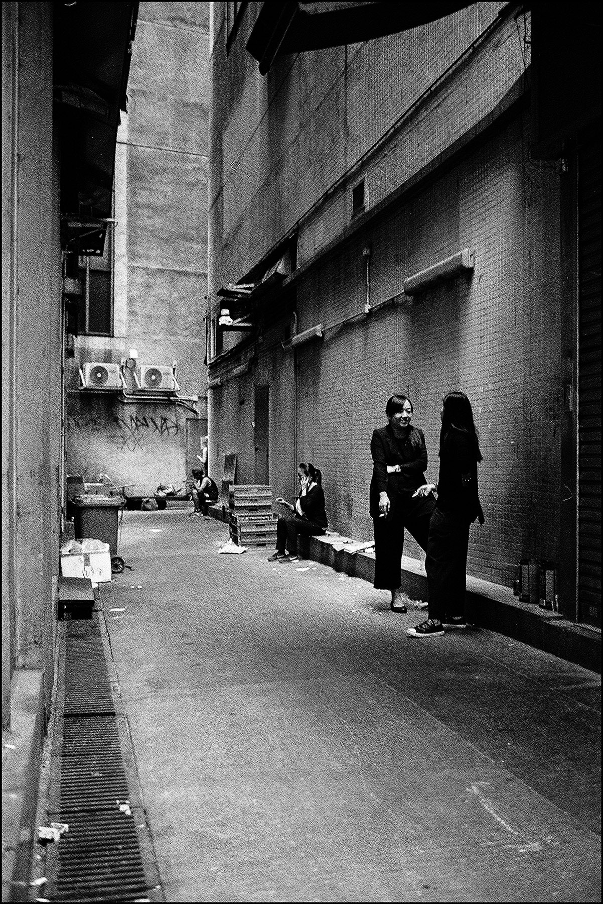 people chatting in a backalley