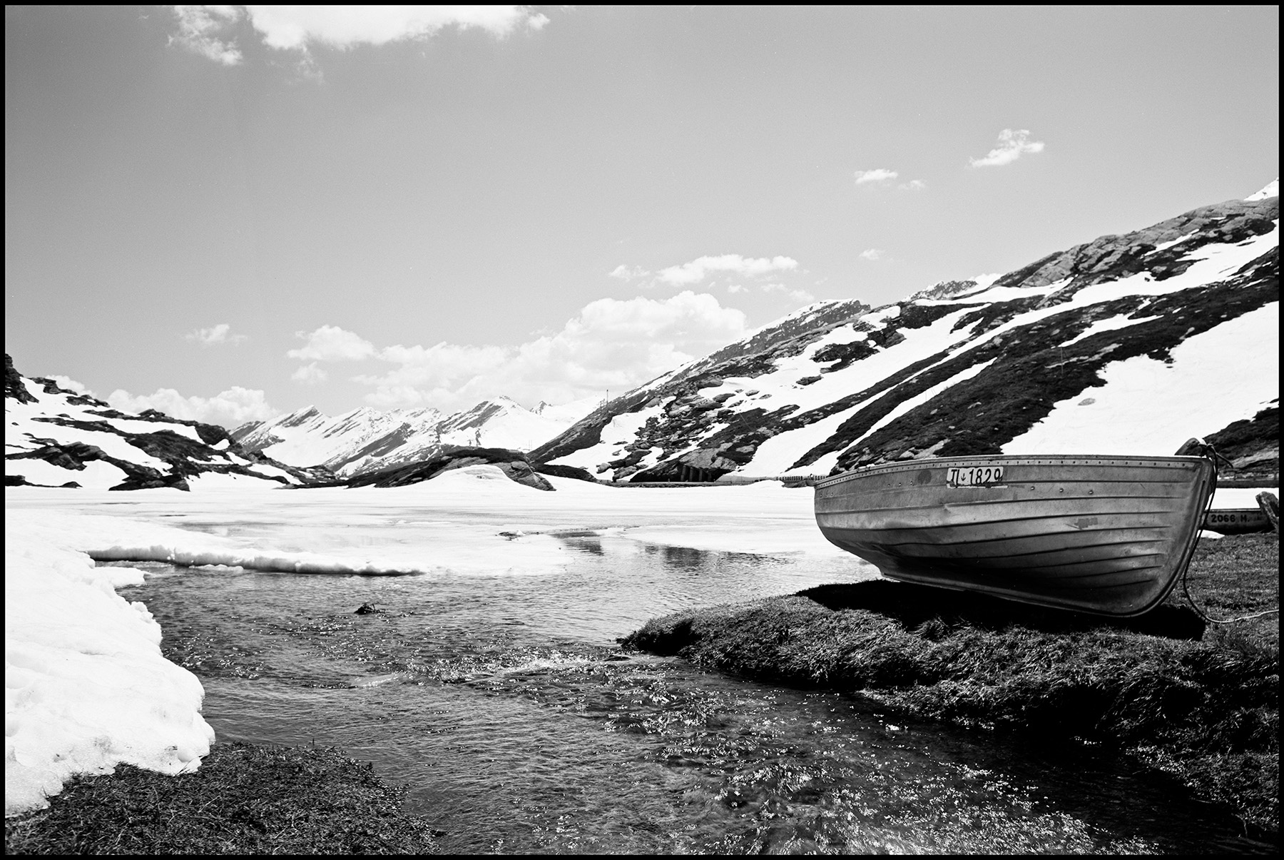 a boat in front of snow covered mountains